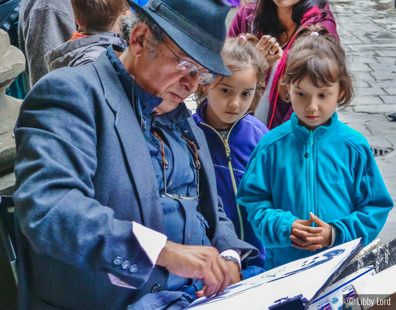 street artist with two young girls by Libby Lord