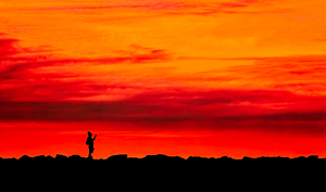A Picture of a Man Taking a Picture of a Sunset - Photo by Ian Veitzer