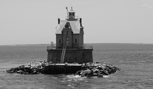 Lighthouse by the sea - Photo by Harold Grimes