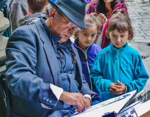 street artist with two young girls - Photo by Libby Lord